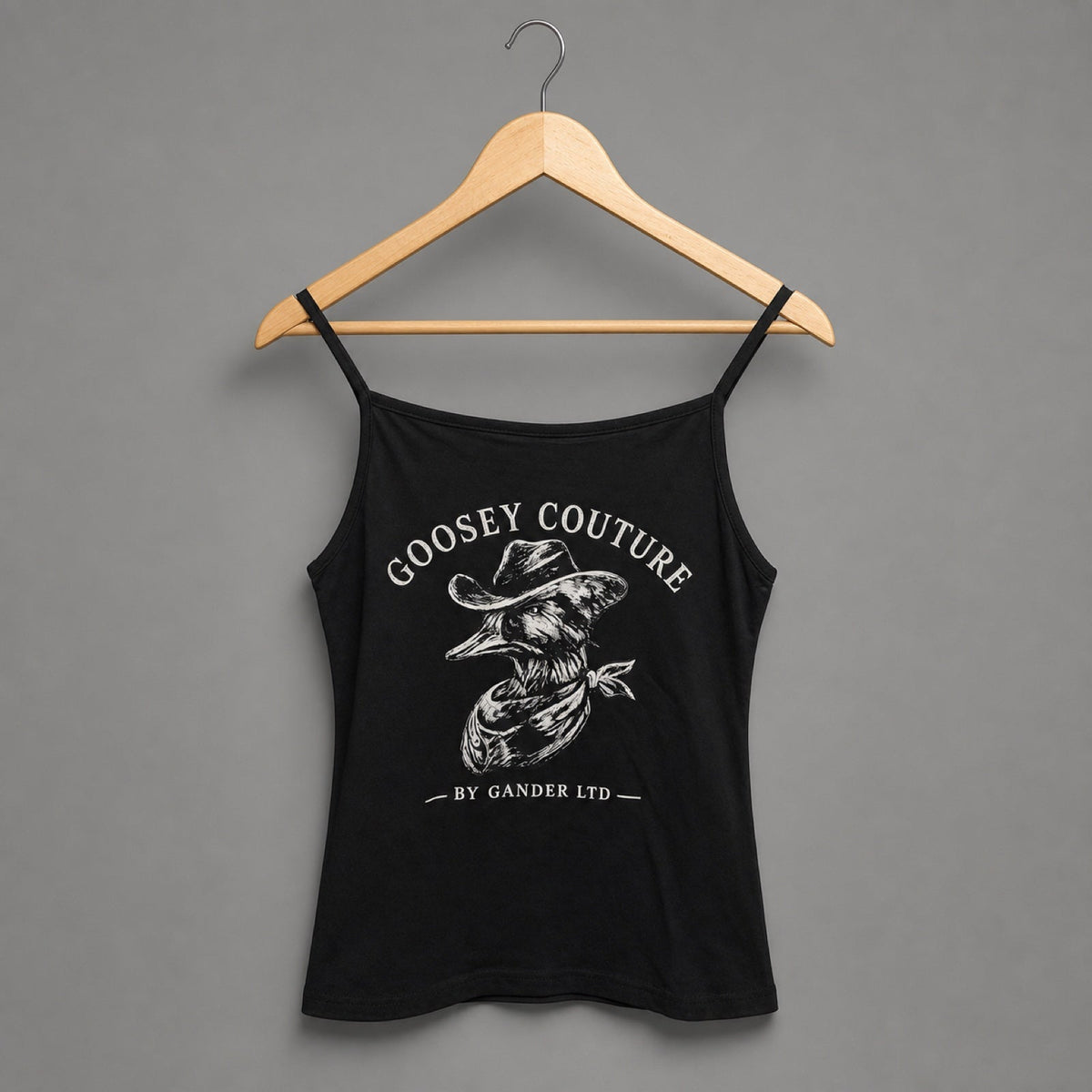 Goosey Couture black printed strappy top back on a Gander wooden hanger