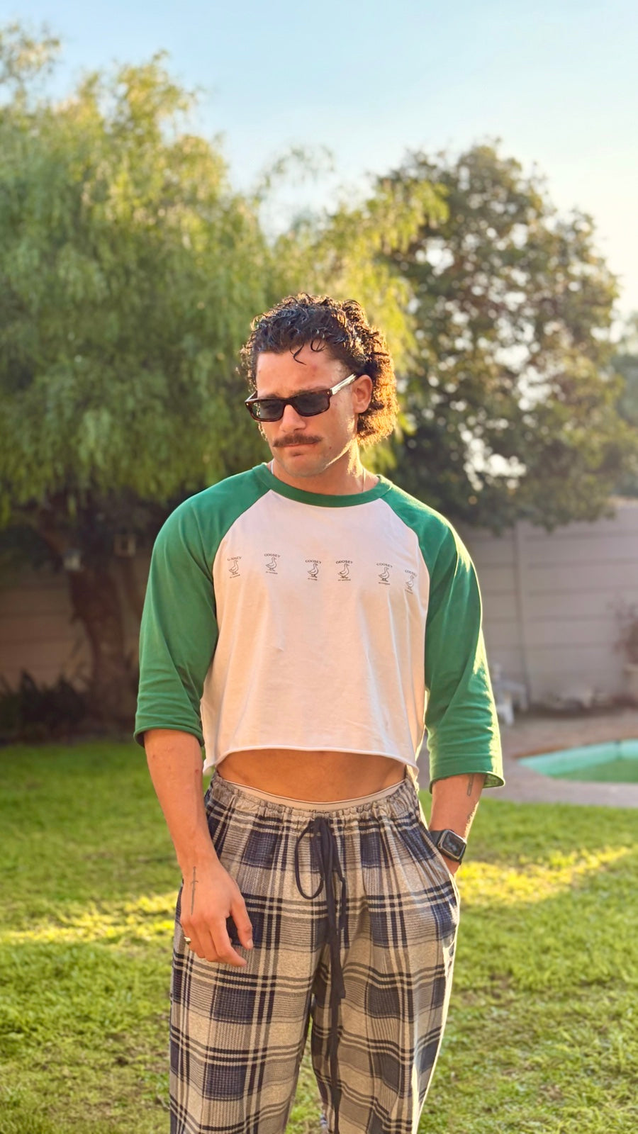 Men’s hand-cropped green Goosey baseball tee in the original editorial