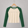 Women’s fitted hand-cropped cream and green Goosey baseball tee on a Gander wooden hanger